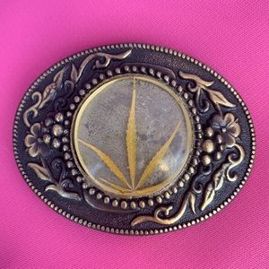 Vintage belt buckle feat. cannabis cast in resin.